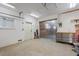 Clean garage with a workbench area, fluorescent lighting and white painted walls at 1721 Allens Creek Dr, Clearwater, FL 33764