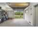 Bright garage with a view of the canal through the open garage door at 1721 Allens Creek Dr, Clearwater, FL 33764