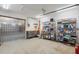 Garage with industrial plastic strip door and shelves for storage and a workbench at 1721 Allens Creek Dr, Clearwater, FL 33764