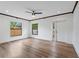 Spacious living room with wood floors, neutral paint, and modern ceiling fan at 1721 Allens Creek Dr, Clearwater, FL 33764
