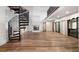Spacious living room with a fireplace, spiral staircase, and sliding glass doors at 1721 Allens Creek Dr, Clearwater, FL 33764
