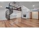 Living room boasting a spiral staircase, fireplace, and wood floors at 1721 Allens Creek Dr, Clearwater, FL 33764