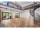 Spacious living room with wood floors, a spiral staircase, and access to an outdoor patio at 1721 Allens Creek Dr, Clearwater, FL 33764