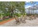 Covered patio with outdoor seating, with serene views of lush trees and tropical landscaping at 1721 Allens Creek Dr, Clearwater, FL 33764