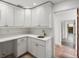 Well-organized pantry features white cabinets, quartz countertops, and bronze hardware for a clean, modern look at 1721 Allens Creek Dr, Clearwater, FL 33764