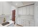 Bright pantry with white cabinets, quartz countertops, and bronze hardware offers ample storage and style at 1721 Allens Creek Dr, Clearwater, FL 33764