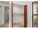 Pantry offers storage solutions with white cabinets, quartz countertops and shelves at 1721 Allens Creek Dr, Clearwater, FL 33764