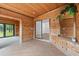 Enclosed porch with wood paneled walls, tile floors and sliding door to an outdoor space at 1721 Allens Creek Dr, Clearwater, FL 33764