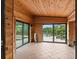 Enclosed porch with wood walls, tile flooring, and sliding doors leading to the pool and dock at 1721 Allens Creek Dr, Clearwater, FL 33764