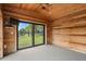 Bright sunroom with wood paneled walls and floor-to-ceiling windows at 1721 Allens Creek Dr, Clearwater, FL 33764