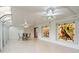 Bright sunroom featuring marble tile floors, stained glass windows, and decorative lighting at 1721 Allens Creek Dr, Clearwater, FL 33764