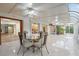 Light-filled sunroom with glass ceiling, tile floor, stained glass windows and a decorative ceiling fan at 1721 Allens Creek Dr, Clearwater, FL 33764