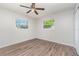 Bedroom features wood-look floors and windows with leafy views at 1839 Neptune Dr, Englewood, FL 34223