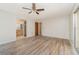 Spacious bedroom with wood-look floors, access to an en-suite bathroom and walk-in closet at 1839 Neptune Dr, Englewood, FL 34223