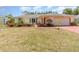 Charming single-story home with well-maintained front yard and inviting red accents on the driveway and entrance at 1839 Neptune Dr, Englewood, FL 34223
