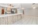 Open kitchen area featuring a breakfast bar, stainless steel appliances, and easy access to the living area at 1839 Neptune Dr, Englewood, FL 34223