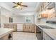 Kitchen with tiled floor, countertops and cabinets plus ceiling fan and modern appliances at 1839 Neptune Dr, Englewood, FL 34223