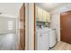 Practical laundry room with modern washer, dryer and storage, conveniently located near living area at 1839 Neptune Dr, Englewood, FL 34223