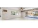 Bright living room with tile flooring and sliding glass doors to the pool at 1839 Neptune Dr, Englewood, FL 34223