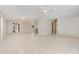 Open concept living area with tiled floors, multiple ceiling fans, and seamless flow to other rooms at 1839 Neptune Dr, Englewood, FL 34223