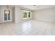 Bright living room boasts tile flooring and a large bay window, perfect for natural light and comfortable living at 1839 Neptune Dr, Englewood, FL 34223