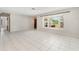 Spacious living room with tile floors and a bright bay window that offers a view of the front yard at 1839 Neptune Dr, Englewood, FL 34223