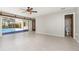Spacious living room with tile flooring, sliding glass doors, and access to a bathroom at 1839 Neptune Dr, Englewood, FL 34223