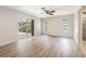 Bright living room with sliding glass door to patio and attractive wood-look flooring at 1839 Neptune Dr, Englewood, FL 34223