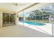Screened-in pool area with a sparkling in-ground pool at 1839 Neptune Dr, Englewood, FL 34223