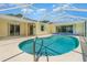 In-ground pool inside screened-in enclosure at 1839 Neptune Dr, Englewood, FL 34223