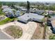 A bird's-eye view of the house, showing the paved driveway, the light gray roof, and its landscaping at 1897 Dolphin S Blvd, St Petersburg, FL 33707