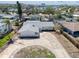 An aerial view displays the neighborhood and layout with circular drive and water views beyond the surrounding homes at 1897 Dolphin S Blvd, St Petersburg, FL 33707