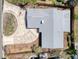 Aerial view of roof with a large circular driveway and partial landscaping and privacy fence at 1897 Dolphin S Blvd, St Petersburg, FL 33707