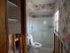Cozy bathroom showcasing a glass-enclosed shower, toilet, and floral wallpaper at 1897 Dolphin S Blvd, St Petersburg, FL 33707
