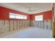 Unfinished bedroom featuring concrete walls, exposed electrical wiring, and natural light from two windows at 1897 Dolphin S Blvd, St Petersburg, FL 33707