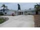 Charming single-story home features a circular driveway and well-maintained landscaping at 1897 Dolphin S Blvd, St Petersburg, FL 33707
