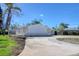 Side view of home showcasing well maintained yard and circular drive at 1897 Dolphin S Blvd, St Petersburg, FL 33707