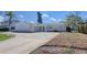 Home exterior with well-maintained circular drive, green grass and healthy landscaping at 1897 Dolphin S Blvd, St Petersburg, FL 33707
