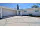 Attached garage and covered porch with brick detailing and a circular driveway at 1897 Dolphin S Blvd, St Petersburg, FL 33707