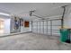 Spacious garage with concrete flooring, large garage door, and overhead lighting at 1897 Dolphin S Blvd, St Petersburg, FL 33707