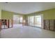 Large living area with sliding glass doors and open access to other rooms, awaiting renovation at 1897 Dolphin S Blvd, St Petersburg, FL 33707