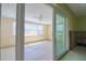 Bright sunroom with tiled floor, ceiling fan, and view to the backyard needing a full renovation at 1897 Dolphin S Blvd, St Petersburg, FL 33707
