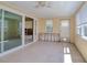 Sunroom with windows, sliding glass doors, ceiling fan, and tiled floors at 1897 Dolphin S Blvd, St Petersburg, FL 33707