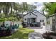 Spacious backyard featuring a deck, patio seating, lush lawn, and mature trees at 1915 10Th N St, St Petersburg, FL 33704