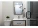 Modern bathroom with a white vanity, framed mirror, and glass-enclosed shower at 1915 10Th N St, St Petersburg, FL 33704