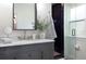 Stylish bathroom with marble countertops, brass fixtures, and a glass-enclosed shower at 1915 10Th N St, St Petersburg, FL 33704