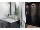 Beautiful bathroom featuring black tiled shower with glass, with marble countertops at 1915 10Th N St, St Petersburg, FL 33704