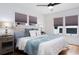 Bright bedroom with hardwood floors, a ceiling fan, a queen bed and three large windows at 1915 10Th N St, St Petersburg, FL 33704