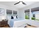 Bright bedroom featuring hardwood floors, a ceiling fan, and three windows for great lighting at 1915 10Th N St, St Petersburg, FL 33704
