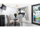 Bright breakfast nook with a glass table, four chairs and a window seat overlooking the pool at 1915 10Th N St, St Petersburg, FL 33704